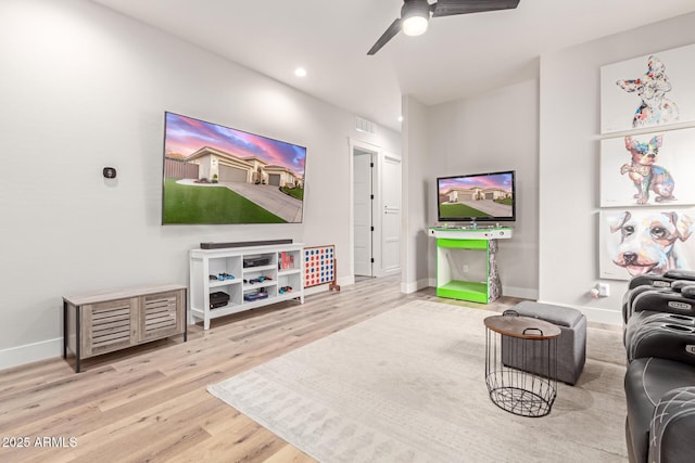 living room featuring ceiling fan and wood-type flooring