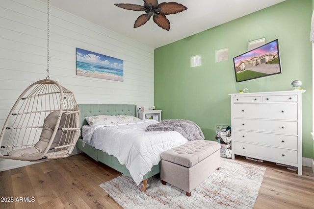 bedroom with hardwood / wood-style floors and ceiling fan