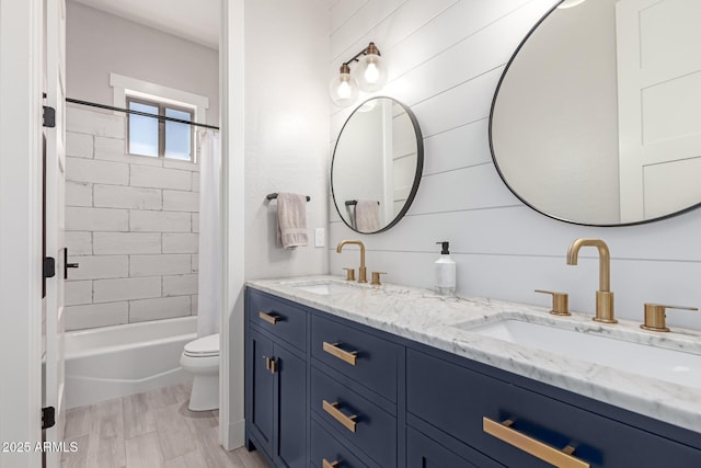 full bathroom with hardwood / wood-style flooring, shower / tub combo with curtain, vanity, and toilet