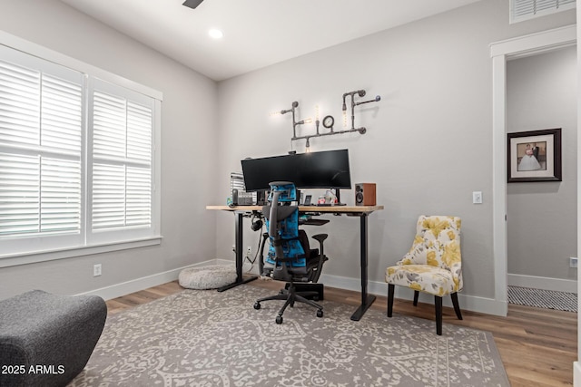 office space with hardwood / wood-style flooring, a wealth of natural light, and ceiling fan