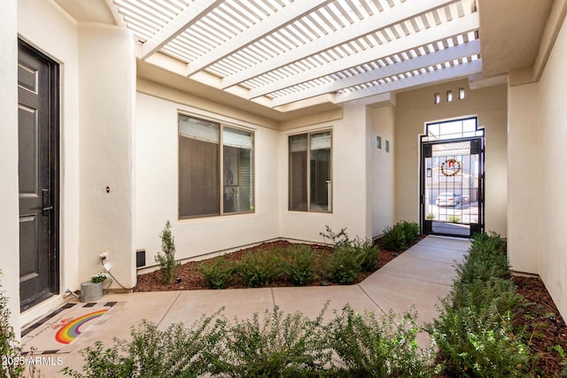 property entrance with a pergola