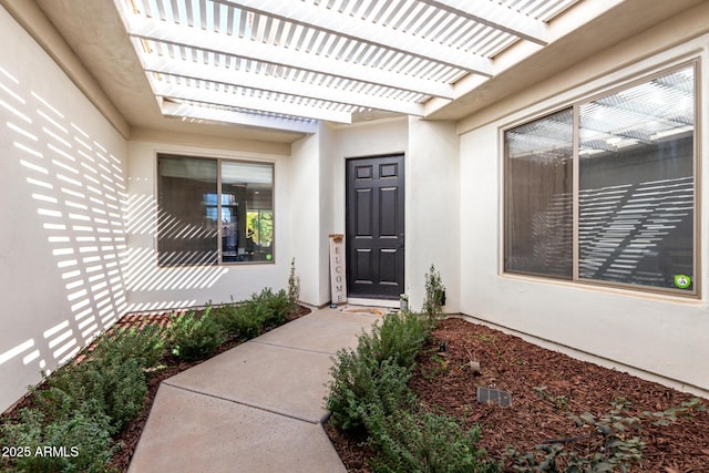 entrance to property with a pergola