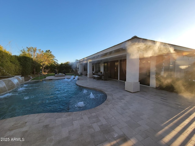 view of pool with a patio area and pool water feature