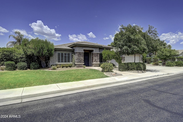 view of front of home with a garage and a front yard