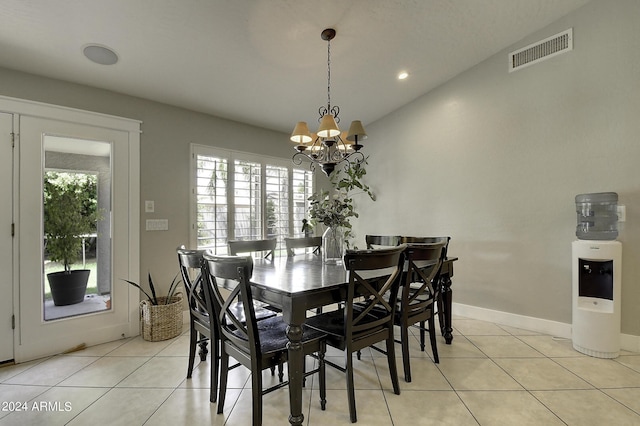 tiled dining area with an inviting chandelier