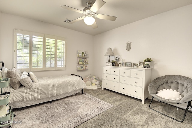 bedroom featuring ceiling fan and carpet