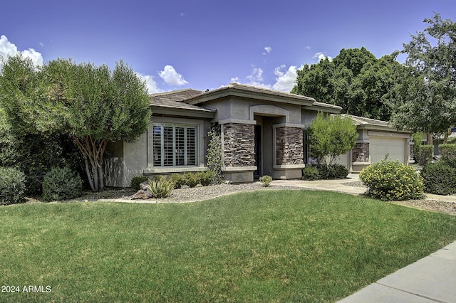 view of front of property with a garage and a front yard