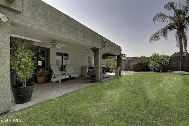 view of yard with ceiling fan and a patio area