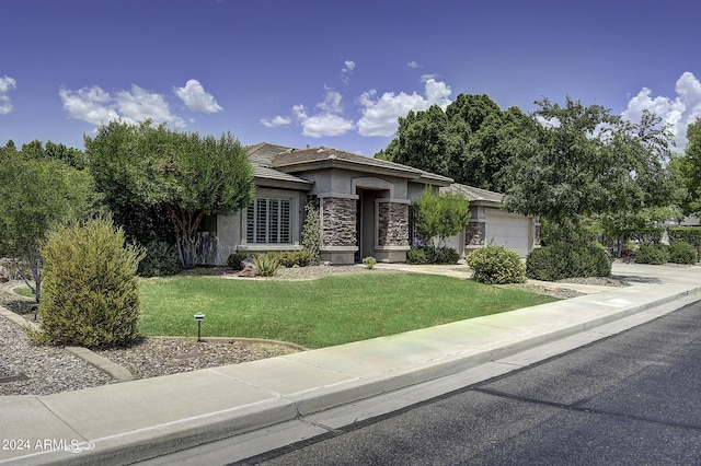 view of front of house with a garage and a front yard