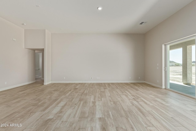 empty room with light hardwood / wood-style flooring