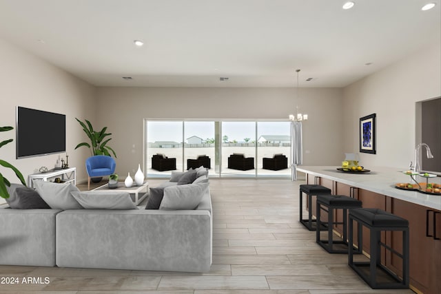 living room with sink, a chandelier, and light wood-type flooring