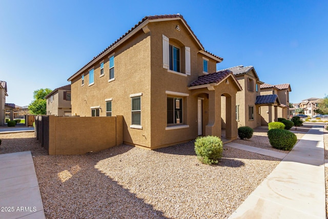 917 E Agua Fria Ln, Avondale, AZ 85323 - view of side of property featuring a tile roof, stucco siding, and a residential view