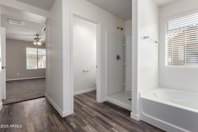 917 E Agua Fria Ln, Avondale, AZ 85323 - full bath with wood finished floors, ceiling fan, a walk in shower, a garden tub, and toilet