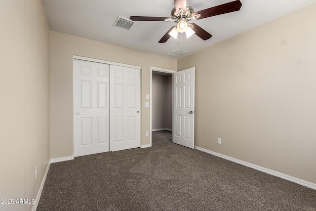 917 E Agua Fria Ln, Avondale, AZ 85323 - unfurnished bedroom featuring dark colored carpet, a closet, baseboards, and a ceiling fan