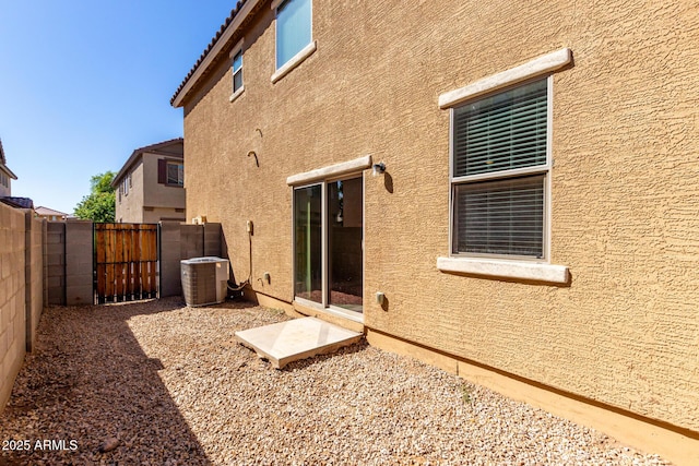 917 E Agua Fria Ln, Avondale, AZ 85323 - rear view of house with stucco siding, a gate, and central AC
