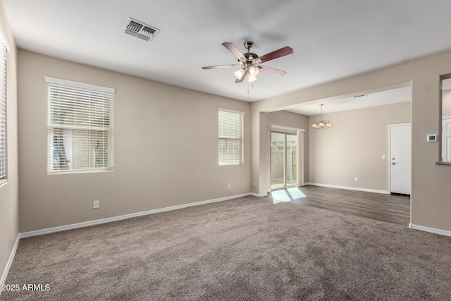 917 E Agua Fria Ln, Avondale, AZ 85323 - carpeted spare room featuring a ceiling fan, baseboards, and a chandelier