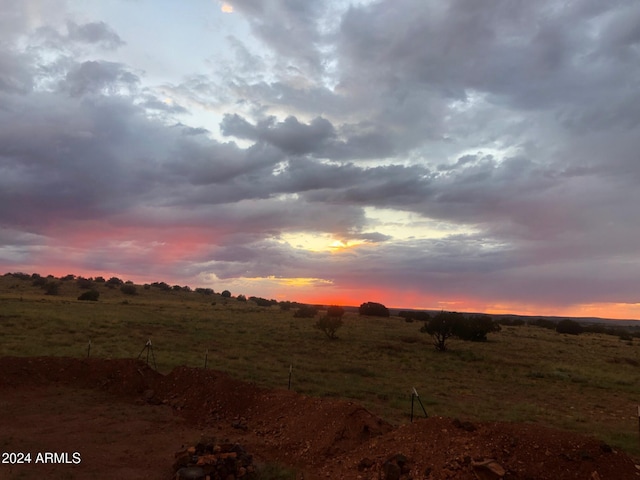 nature at dusk featuring a rural view