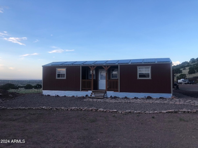 manufactured / mobile home with a porch and solar panels