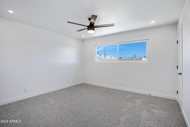 carpeted spare room with ceiling fan