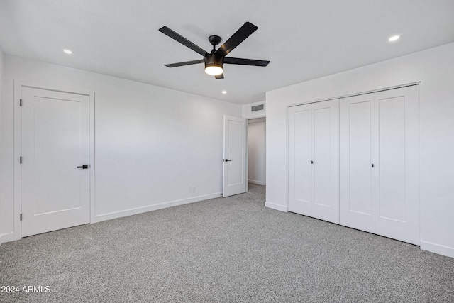 unfurnished bedroom with carpet, ceiling fan, and a closet