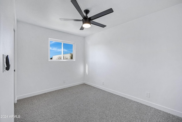 unfurnished room with ceiling fan and carpet