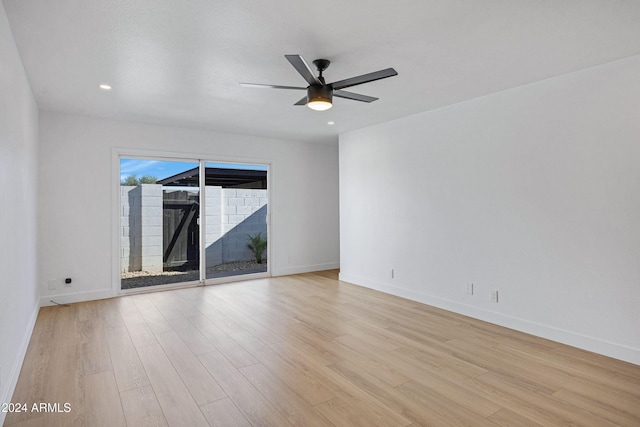 empty room with light hardwood / wood-style flooring and ceiling fan