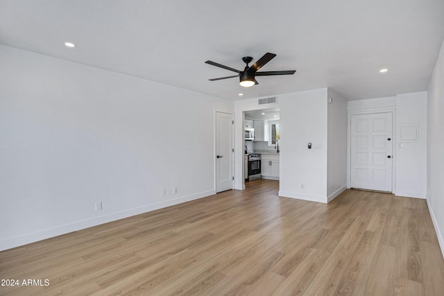 interior space featuring light hardwood / wood-style flooring, ceiling fan, and sink