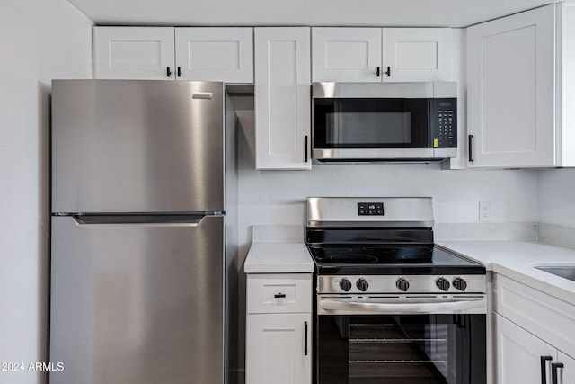 kitchen with white cabinetry and appliances with stainless steel finishes