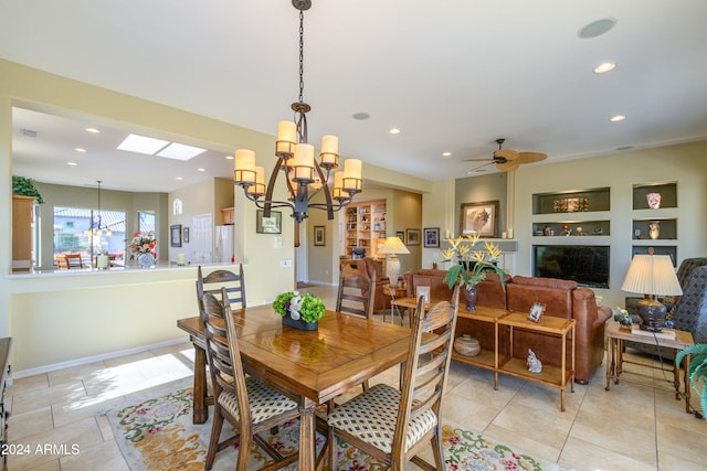 dining space with built in shelves and ceiling fan with notable chandelier