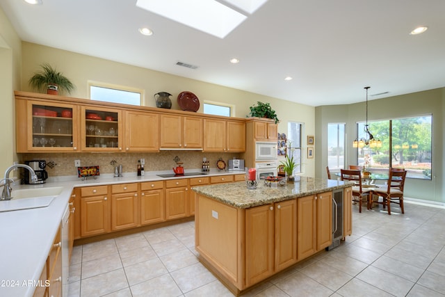 kitchen featuring white appliances, sink, decorative backsplash, decorative light fixtures, and a chandelier