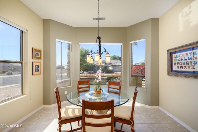 tiled dining room featuring a notable chandelier