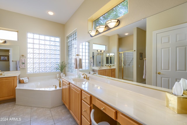 bathroom featuring shower with separate bathtub, vanity, and tile patterned floors