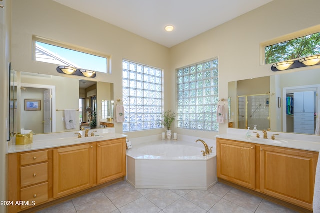 bathroom with tile patterned flooring, separate shower and tub, and a wealth of natural light