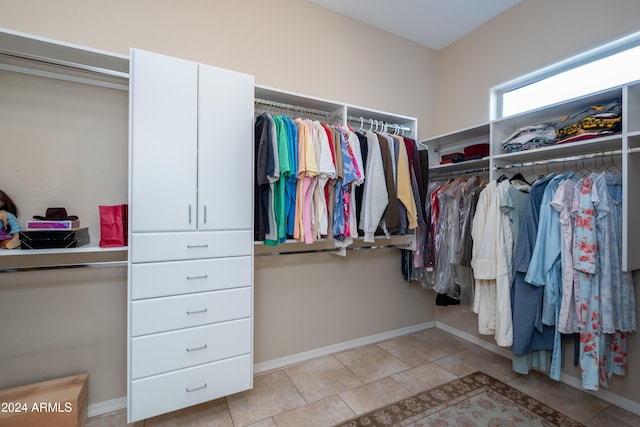 spacious closet with light tile patterned floors