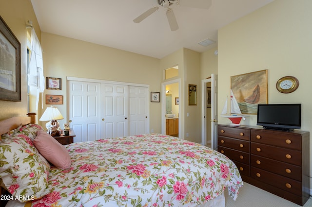 bedroom with ensuite bath, ceiling fan, a closet, and carpet floors