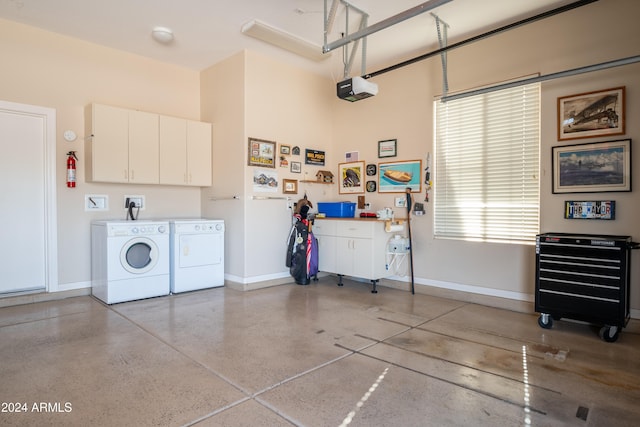 garage with washer and clothes dryer and a garage door opener