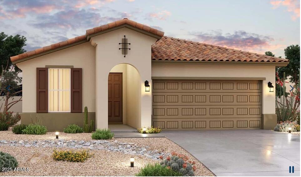 1339 S 215th Dr, Buckeye, AZ 85326 - mediterranean / spanish-style house featuring a tiled roof, a garage, driveway, and stucco siding
