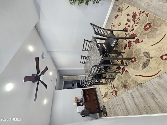 dining area featuring visible vents, wood finished floors, and a ceiling fan