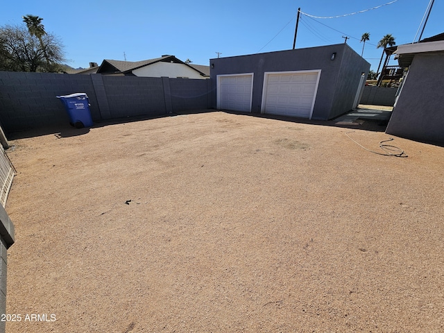 exterior space with an outdoor structure and fence