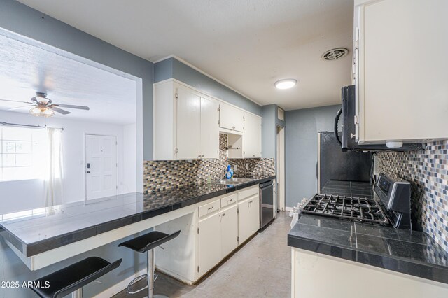 512 N Ironwood, Mesa, AZ 85201 - kitchen with black appliances, tasteful backsplash, ceiling fan, and concrete floors