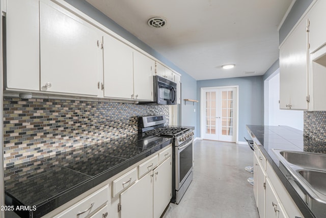 512 N Ironwood, Mesa, AZ 85201 - kitchen featuring gas stove, black microwave, tasteful backsplash, french doors, and concrete flooring