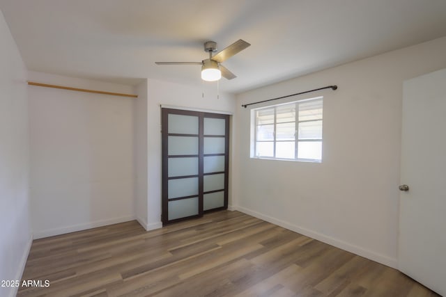 512 N Ironwood, Mesa, AZ 85201 - unfurnished bedroom with wood finished floors, a closet, baseboards, and a ceiling fan