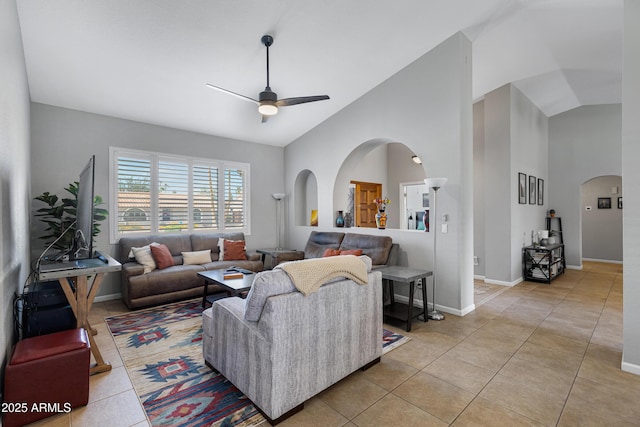 1231 E Sunburst Ln, Tempe, AZ 85284 - living room with arched walkways, ceiling fan, vaulted ceiling, light tile patterned floors, and baseboards