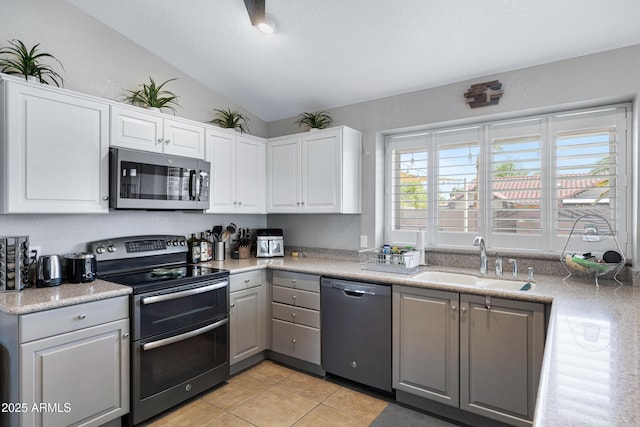 1231 E Sunburst Ln, Tempe, AZ 85284 - kitchen featuring appliances with stainless steel finishes, lofted ceiling, a sink, light tile patterned floors, and gray cabinetry