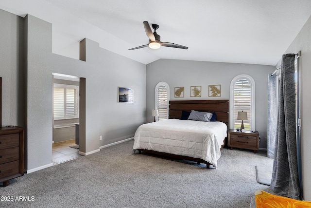 1231 E Sunburst Ln, Tempe, AZ 85284 - bedroom featuring multiple windows, carpet, vaulted ceiling, ensuite bath, and a ceiling fan