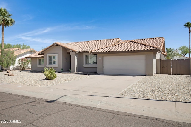 1231 E Sunburst Ln, Tempe, AZ 85284 - view of front of property with stucco siding, an attached garage, a tile roof, and concrete driveway