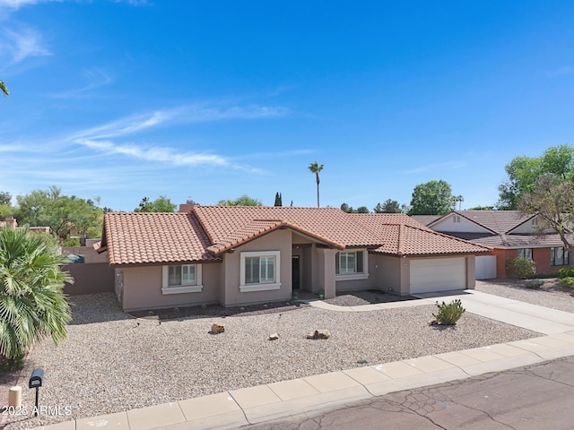 1231 E Sunburst Ln, Tempe, AZ 85284 - ranch-style house with a tiled roof, concrete driveway, a garage, and stucco siding