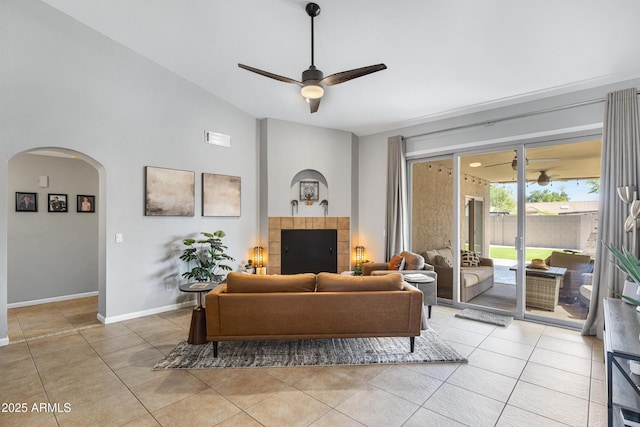 1231 E Sunburst Ln, Tempe, AZ 85284 - living room featuring a ceiling fan, arched walkways, light tile patterned floors, lofted ceiling, and baseboards