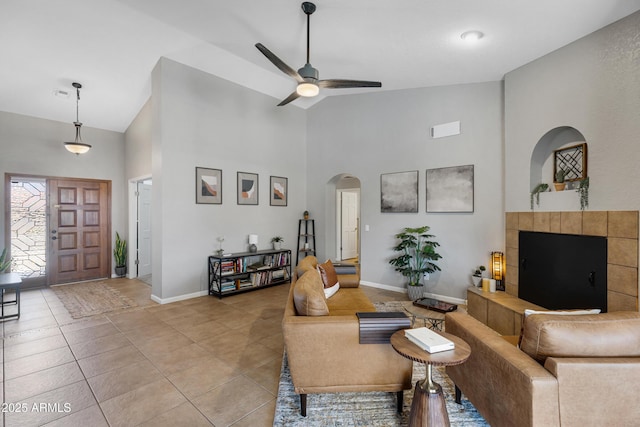 1231 E Sunburst Ln, Tempe, AZ 85284 - living room with high vaulted ceiling, arched walkways, ceiling fan, baseboards, and light tile patterned flooring