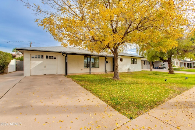 view of front of home featuring a garage and a front yard